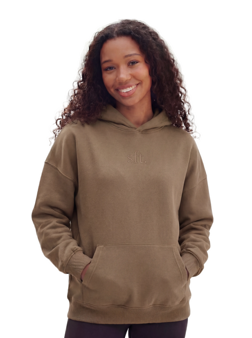 Woman wearing a brown hoodie with a logo on a white background