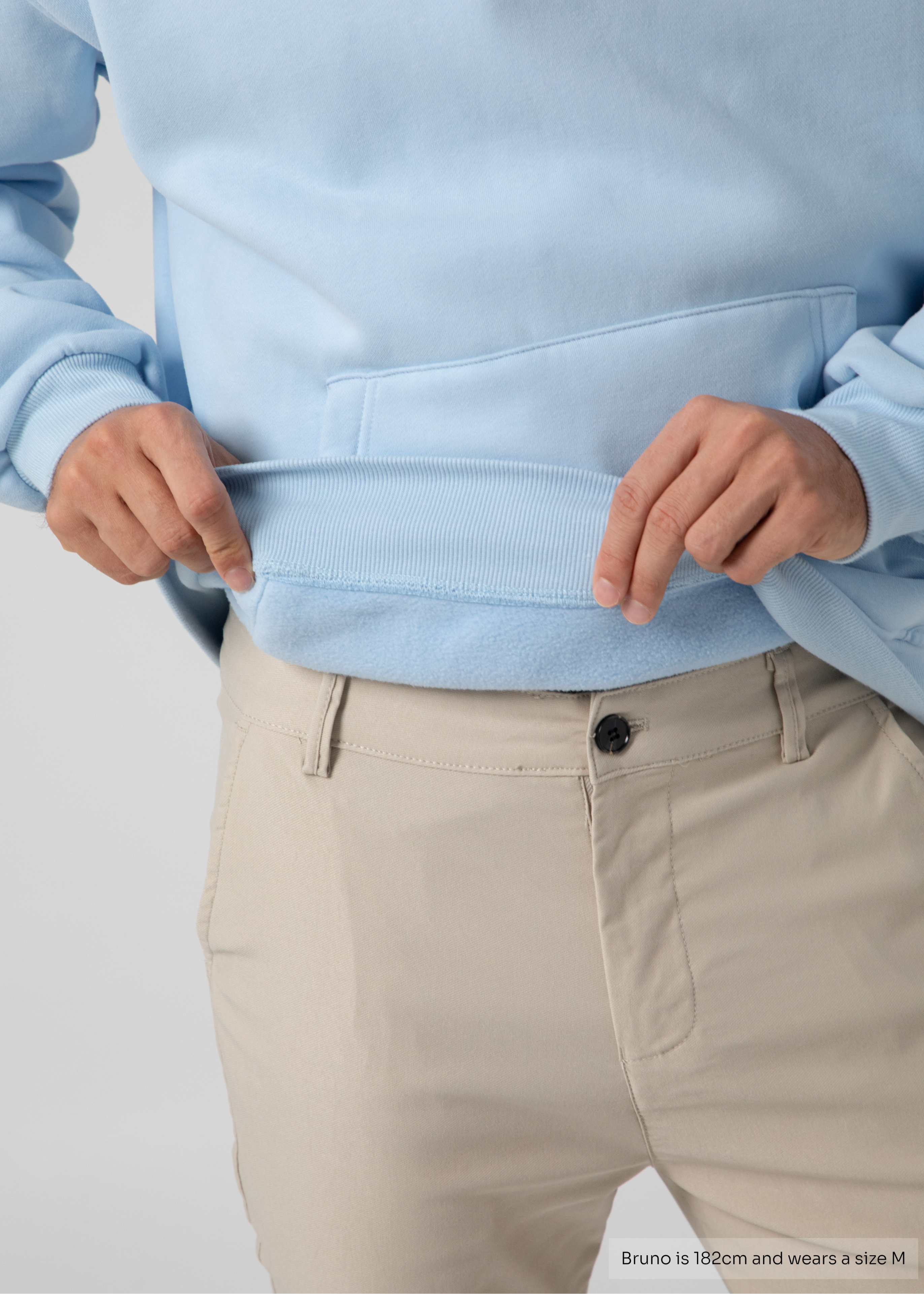 Light blue sweater worn by a person on a plain background